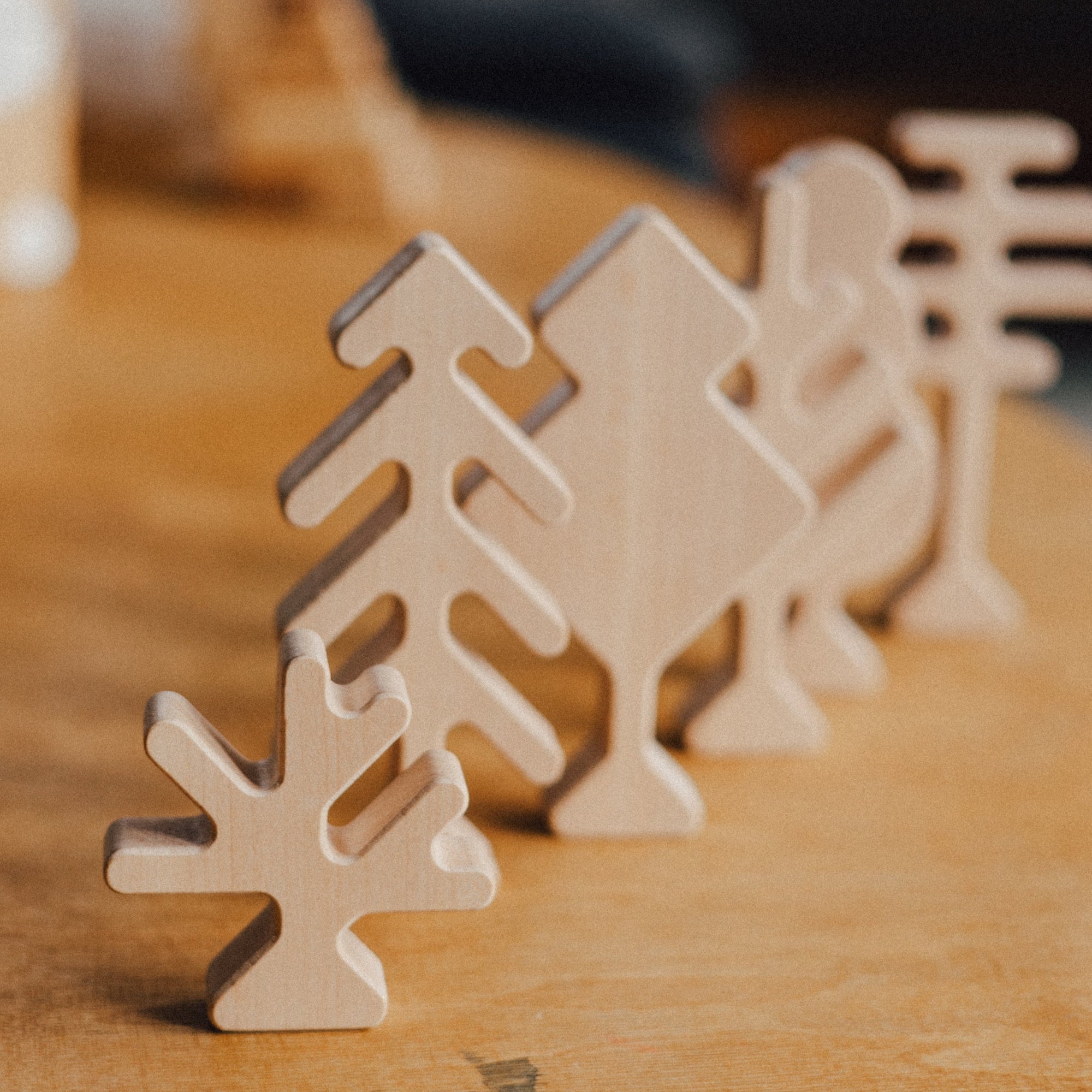Wooden Christmas tree ornaments on a wooden surface