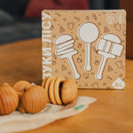 Packaging of rattlets with illustrations on a wooden table