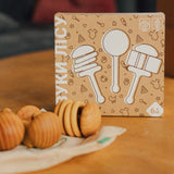 Packaging of rattlets with illustrations on a wooden table