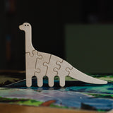 Wooden dinosaur puzzle on a board game
