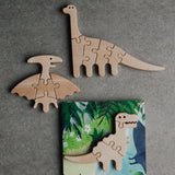 Wooden dinosaur puzzles on a gray background