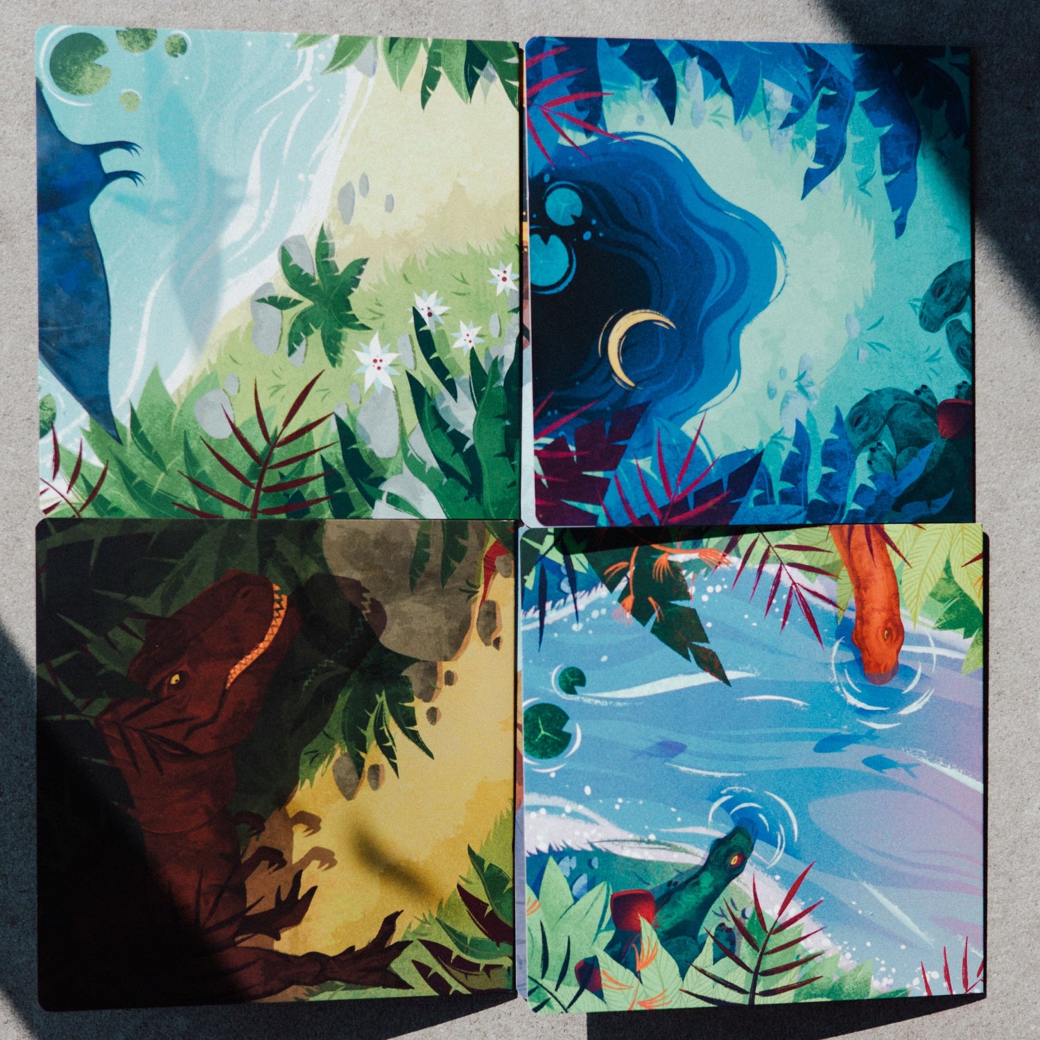 Four colorful nature-themed cards on a gray surface